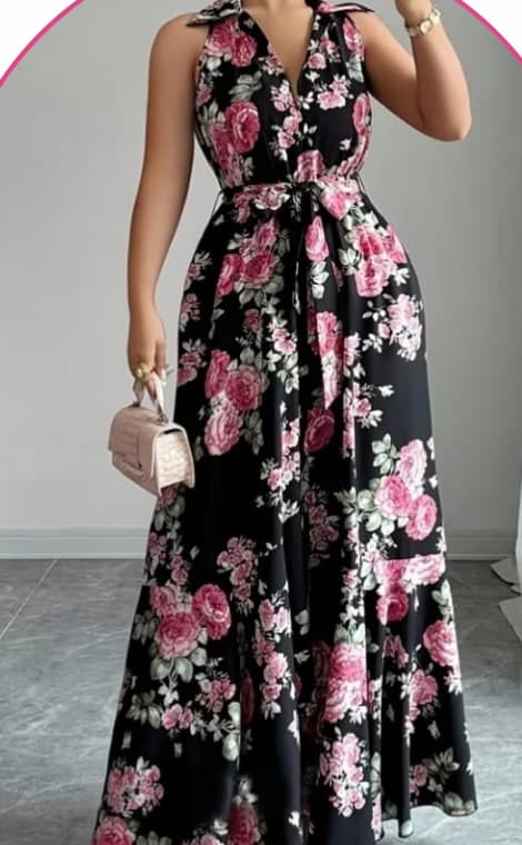 Model wearing a black maxi dress with a pink floral print and tie waist