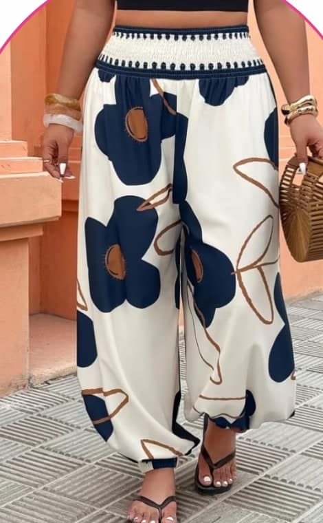 Model wearing cream wide-leg pants with a navy floral print