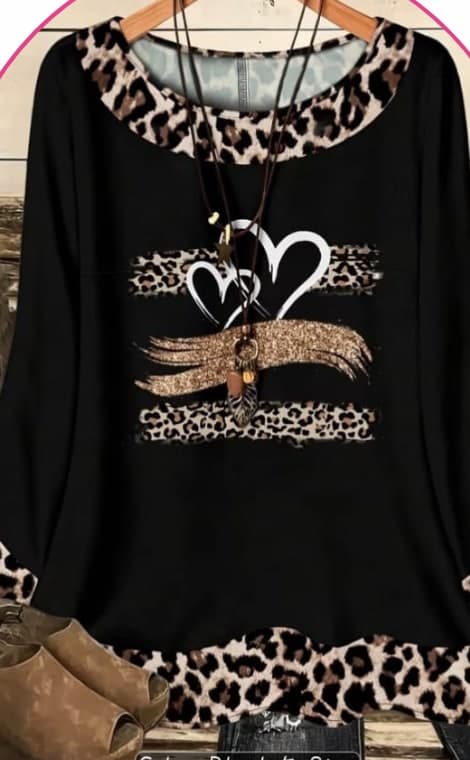 Model wearing a black long-sleeve top with a leopard-print heart graphic
