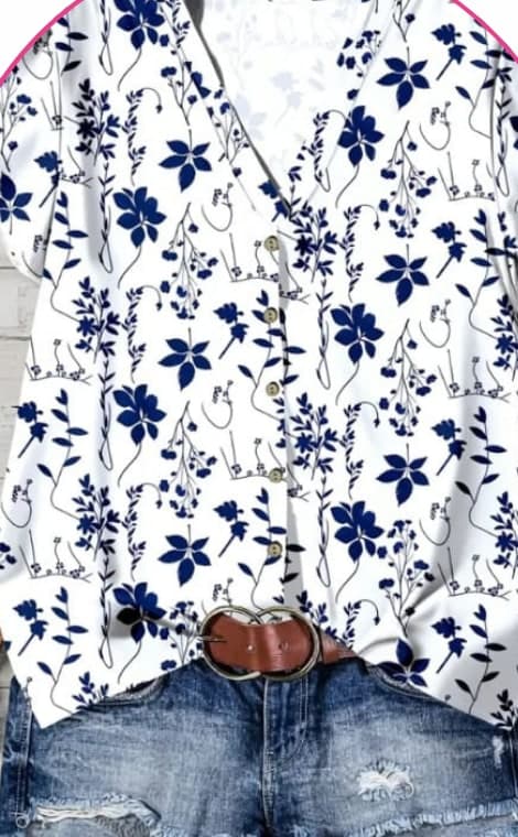 White and navy floral button-front blouse on a hanger