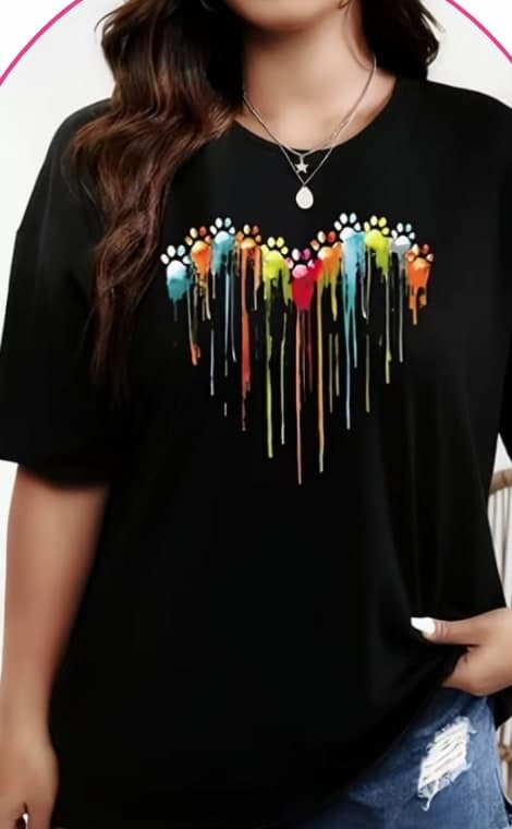 Model wearing a black tee with a colourful paint-drip heart graphic