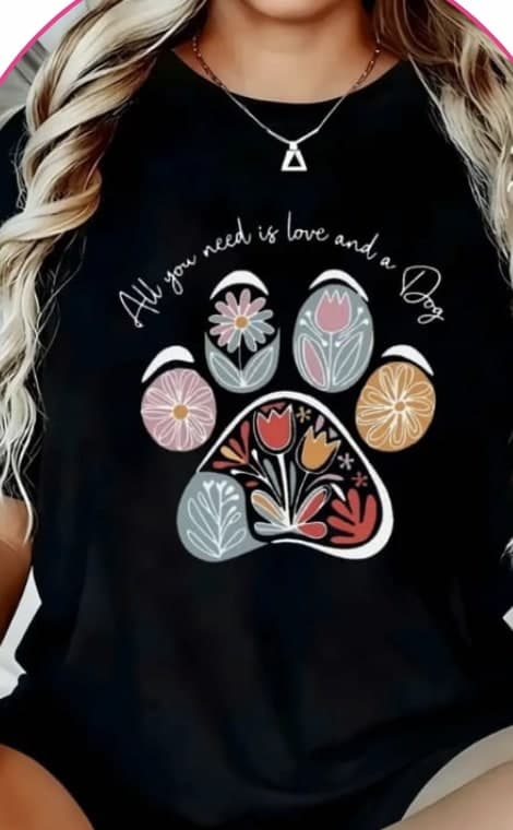 Model wearing a black oversized tee with a floral paw print graphic