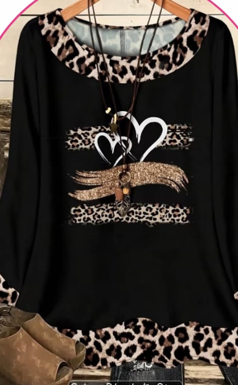 Model wearing a black long-sleeve top with a leopard-print heart graphic